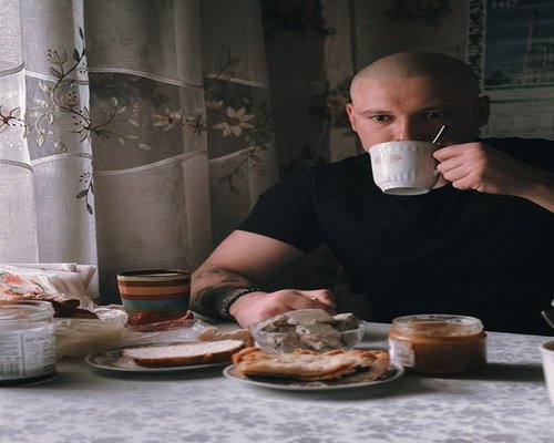 Man having simple breakfast and coffee at home in Hungary before work